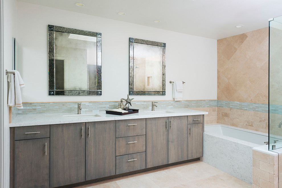 Inspiration for a mid-sized contemporary master bathroom in Orange County with a drop-in sink, flat-panel cabinets, medium wood cabinets, marble benchtops, an alcove tub, an alcove shower, multi-coloured tile, stone tile, multi-coloured walls and travertine floors.