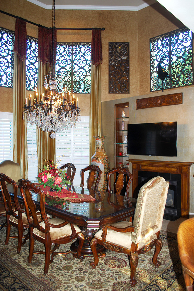 Mid-sized elegant porcelain tile enclosed dining room photo in Houston with brown walls and a standard fireplace