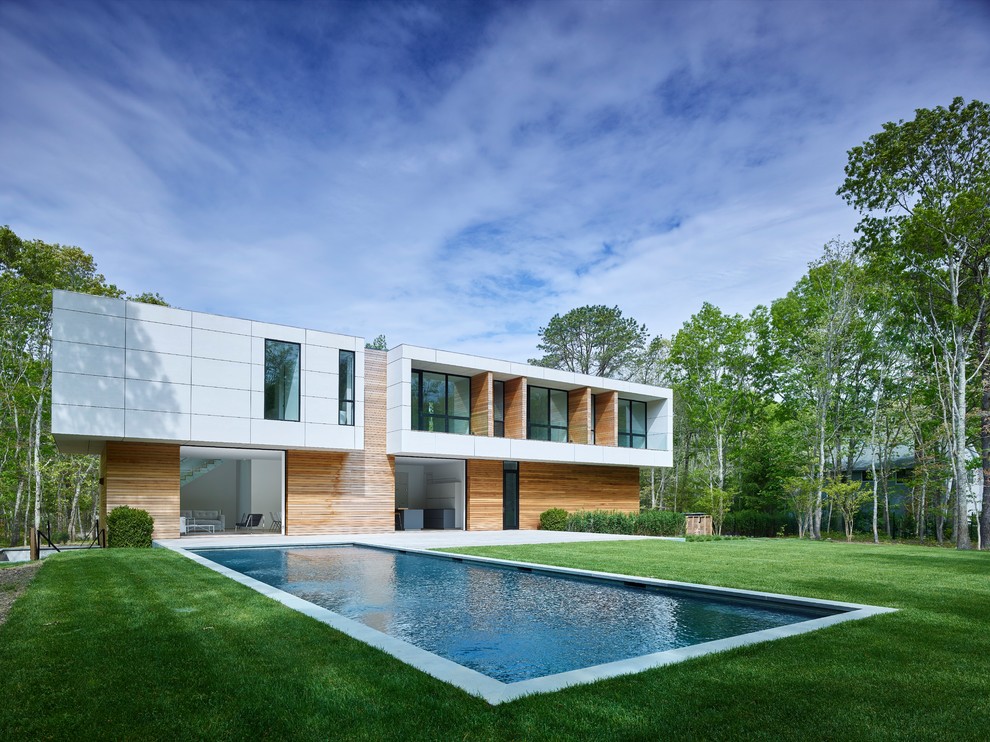 Design ideas for a modern backyard rectangular lap pool in New York.