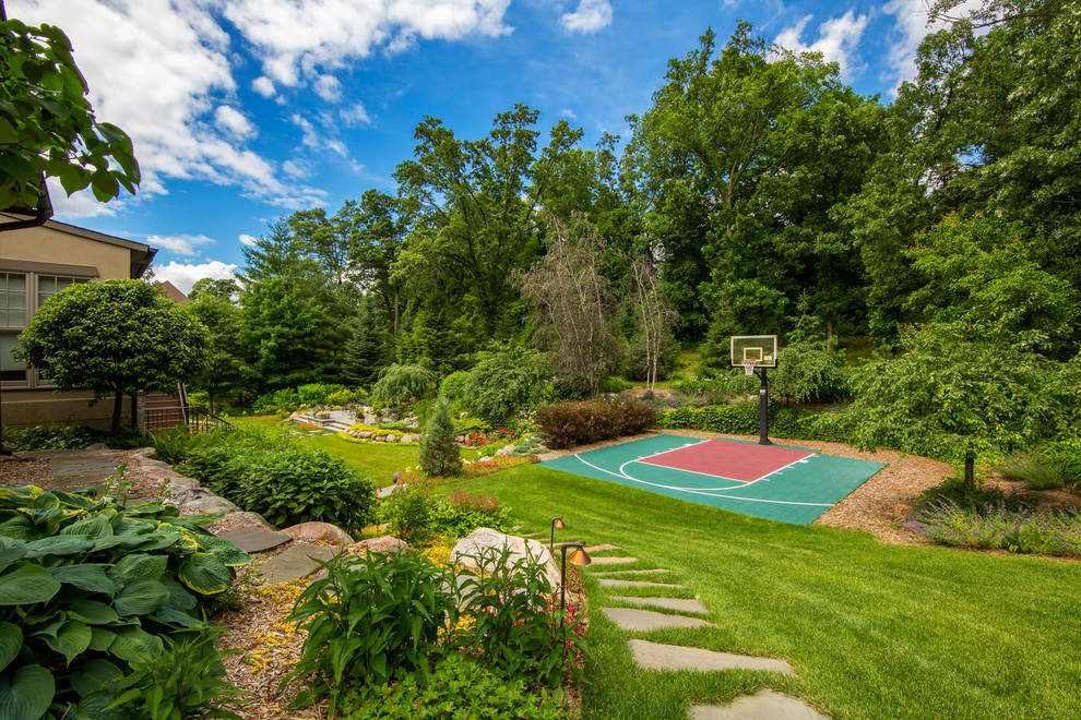 Inspiration for a large mediterranean partial sun backyard stone outdoor basketball/tennis/multi-game court in Minneapolis for summer.