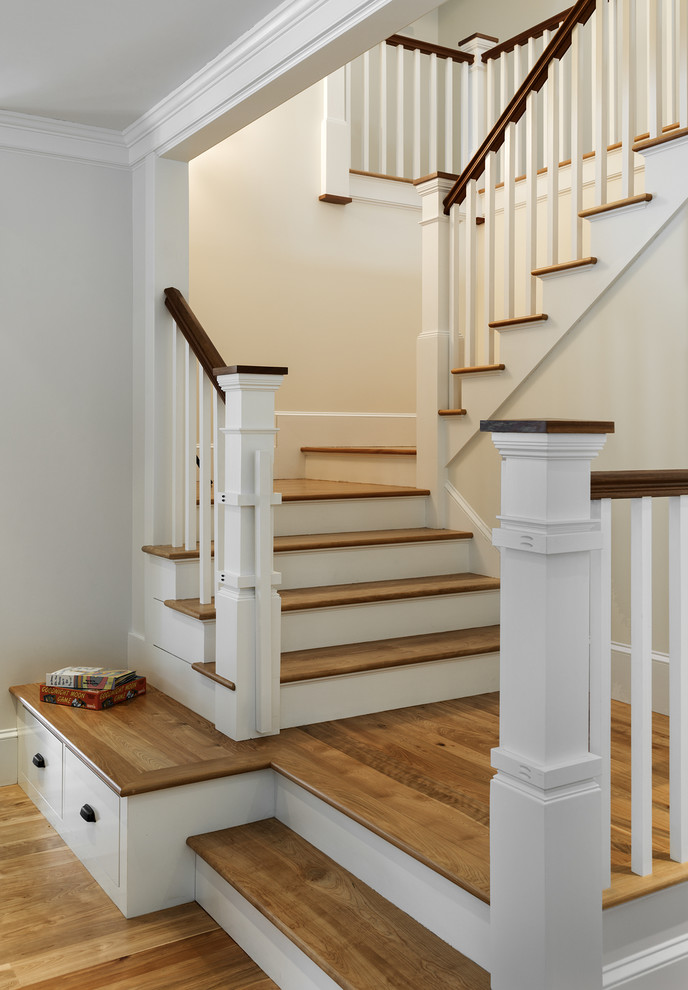 Inspiration for a large traditional wood u-shaped staircase in Portland Maine with painted wood risers.