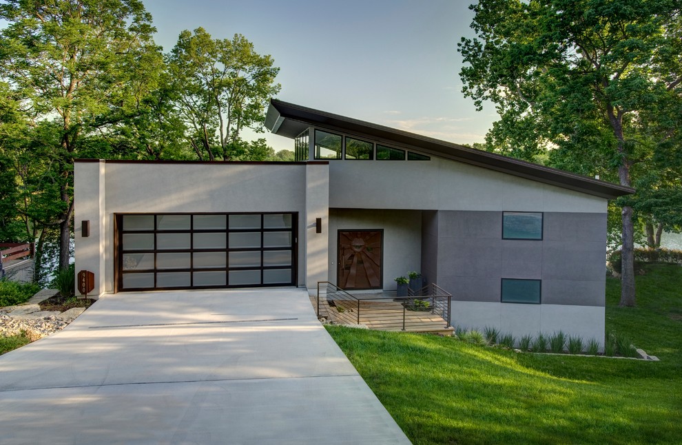 This is an example of a contemporary stucco beige exterior in Kansas City with a shed roof.