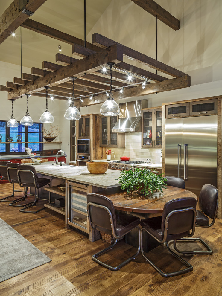Inspiration for a country galley eat-in kitchen in Atlanta with shaker cabinets, medium wood cabinets, yellow splashback, glass tile splashback, stainless steel appliances, medium hardwood floors, with island, brown floor and grey benchtop.