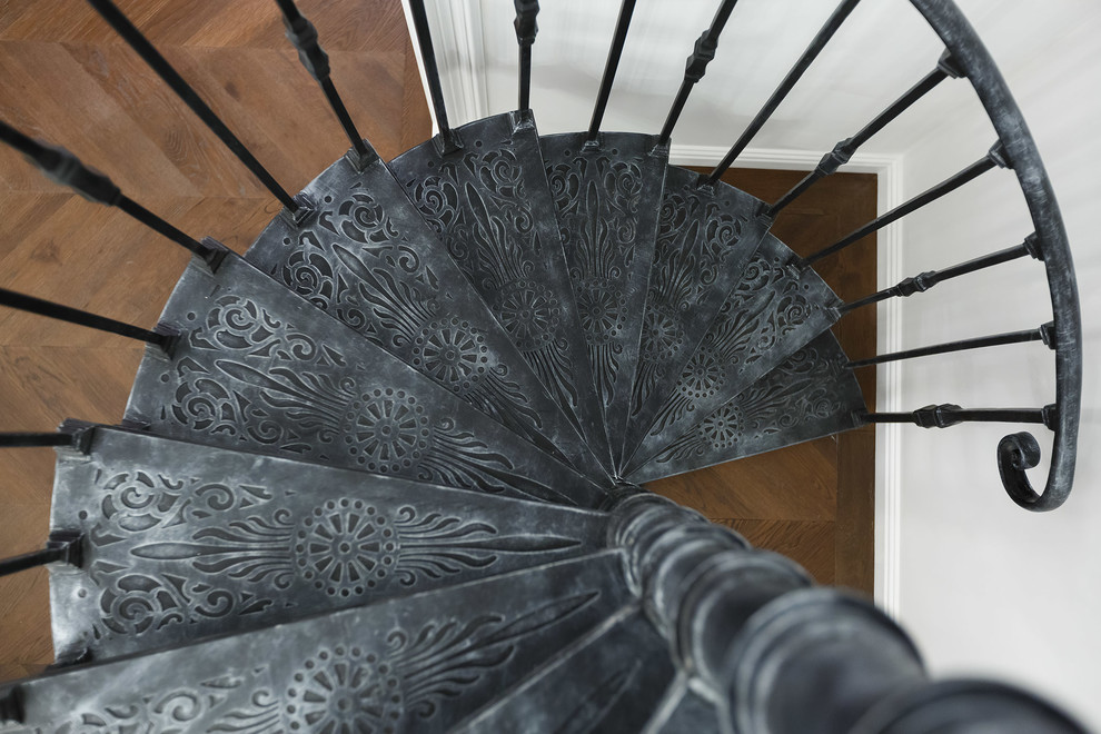 Design ideas for a small transitional metal spiral staircase in Saint Petersburg with metal railing.