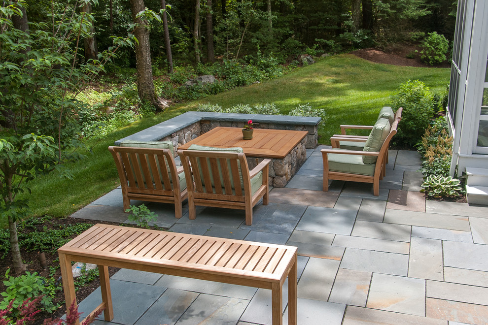 Design ideas for a small traditional backyard partial sun garden in Boston with a fire feature and natural stone pavers.
