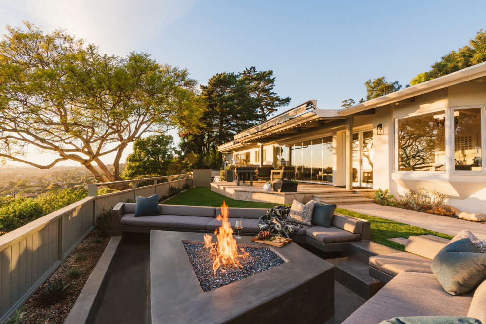 Photo of a modern side yard patio in Santa Barbara with a fire feature and concrete slab.