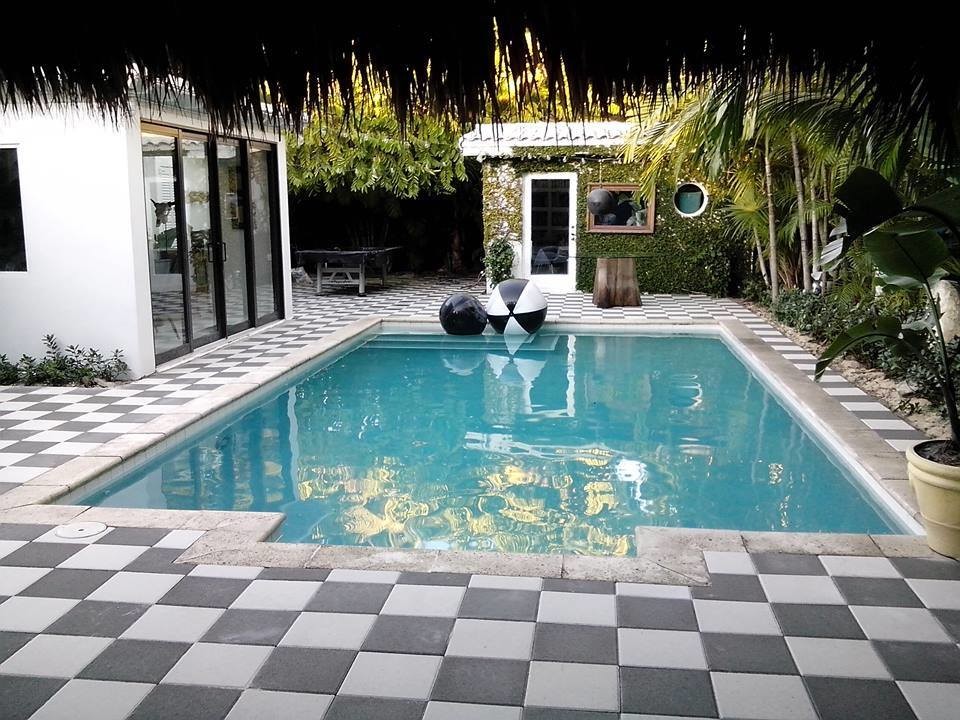 Pool house - mid-sized transitional backyard stone and rectangular lap pool house idea in Miami