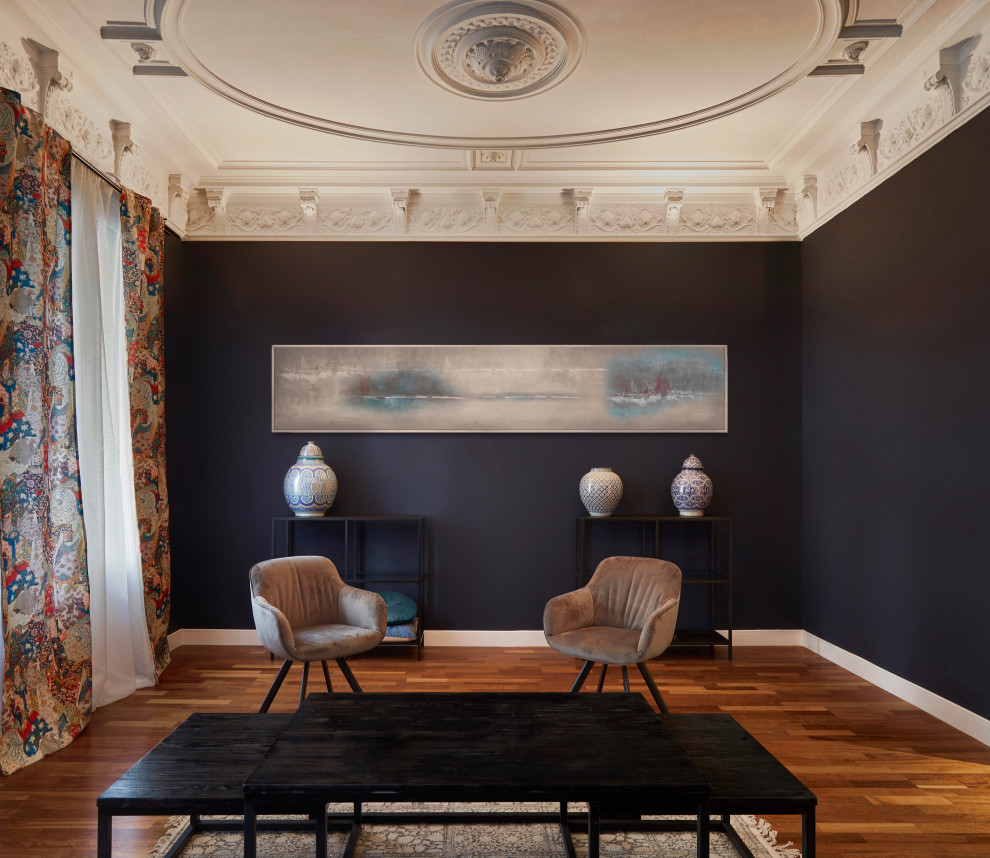 This is an example of a medium sized eclectic formal enclosed living room in Barcelona with black walls, medium hardwood flooring, no fireplace, a wooden fireplace surround, a freestanding tv, beige floors, a coffered ceiling and wainscoting.