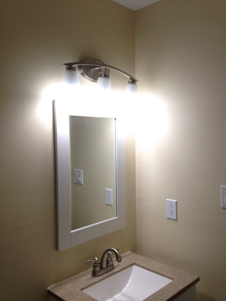 Inspiration for a small transitional 3/4 white tile and porcelain tile porcelain tile alcove bathtub remodel with an integrated sink, flat-panel cabinets, white cabinets, solid surface countertops, a one-piece toilet and beige walls