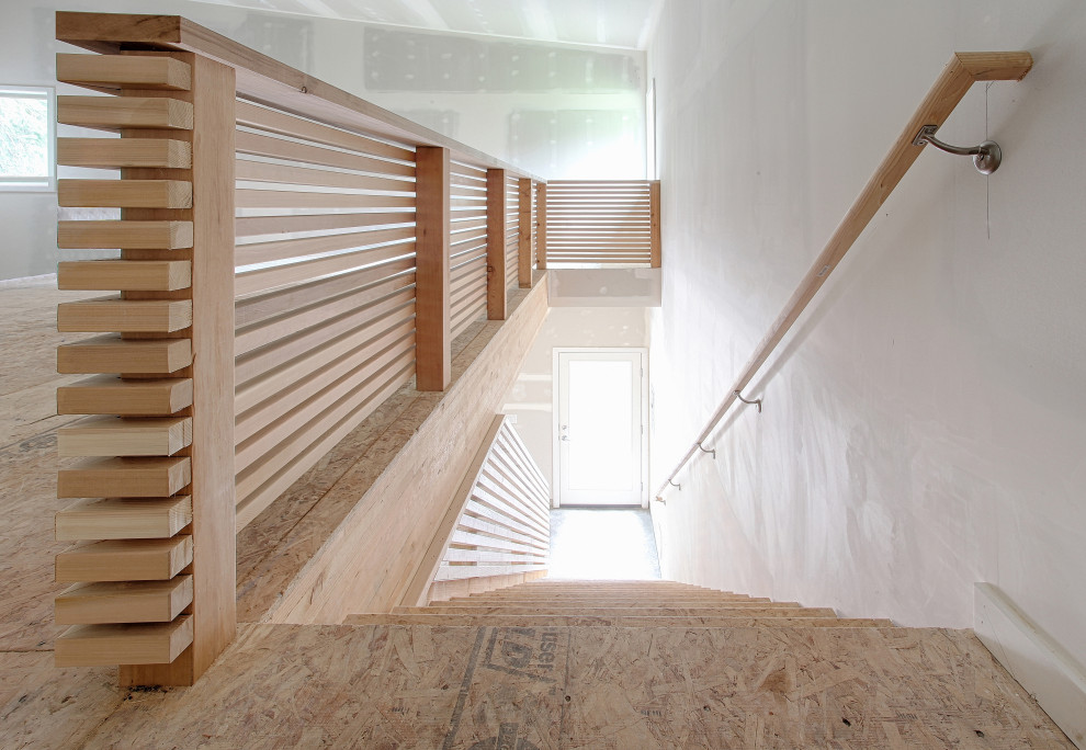 Mid-sized contemporary wood straight staircase in Portland with wood risers and wood railing.