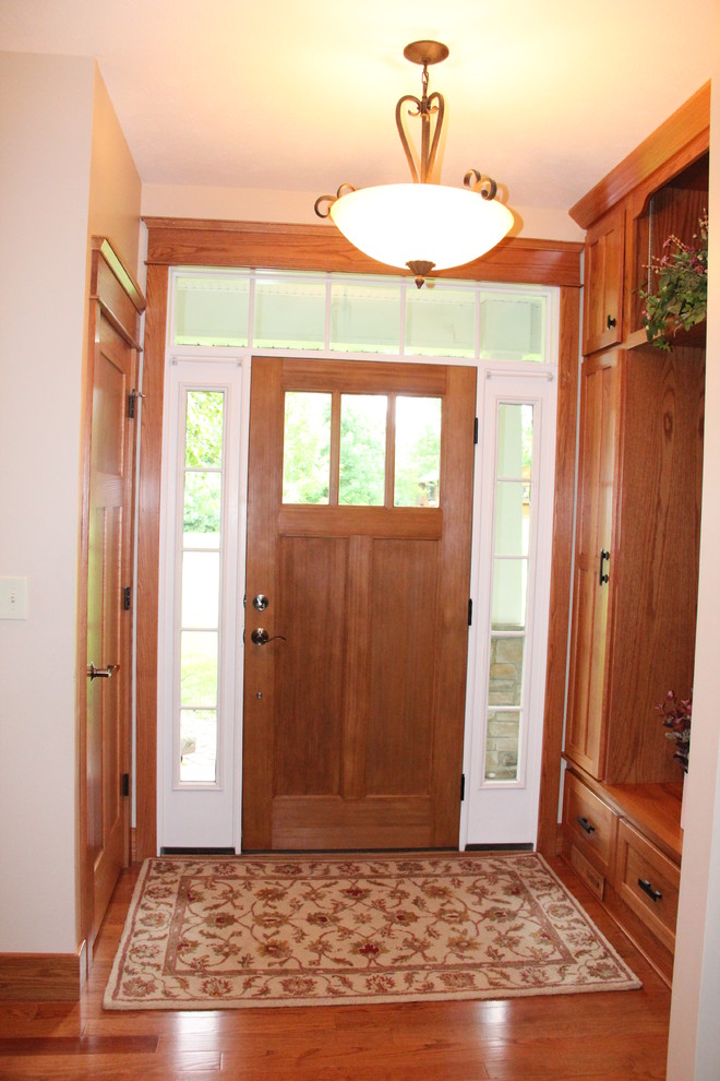 This is an example of an arts and crafts entryway in Chicago with medium hardwood floors.