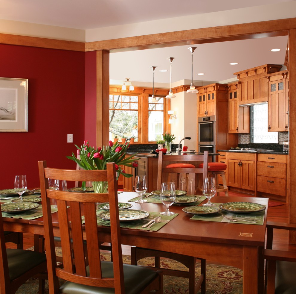 Design ideas for an arts and crafts dining room in Seattle with red walls.