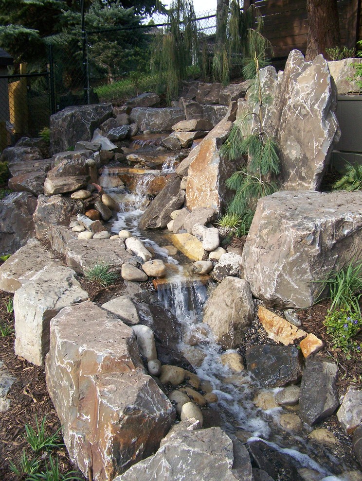 Photo of a huge rustic partial sun backyard formal garden in Calgary for summer.