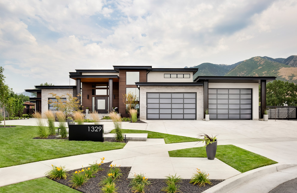 Design ideas for a contemporary one-storey house exterior in Salt Lake City with mixed siding and a flat roof.