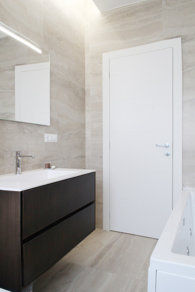 Design ideas for a medium sized contemporary bathroom in Rome with flat-panel cabinets, dark wood cabinets, a hot tub, a two-piece toilet, travertine tiles, travertine flooring, an integrated sink, solid surface worktops, white worktops, a single sink, a floating vanity unit and a drop ceiling.