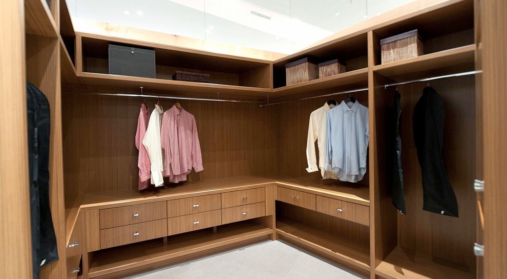 Design ideas for a large contemporary gender-neutral walk-in wardrobe in Vancouver with open cabinets, medium wood cabinets and ceramic floors.