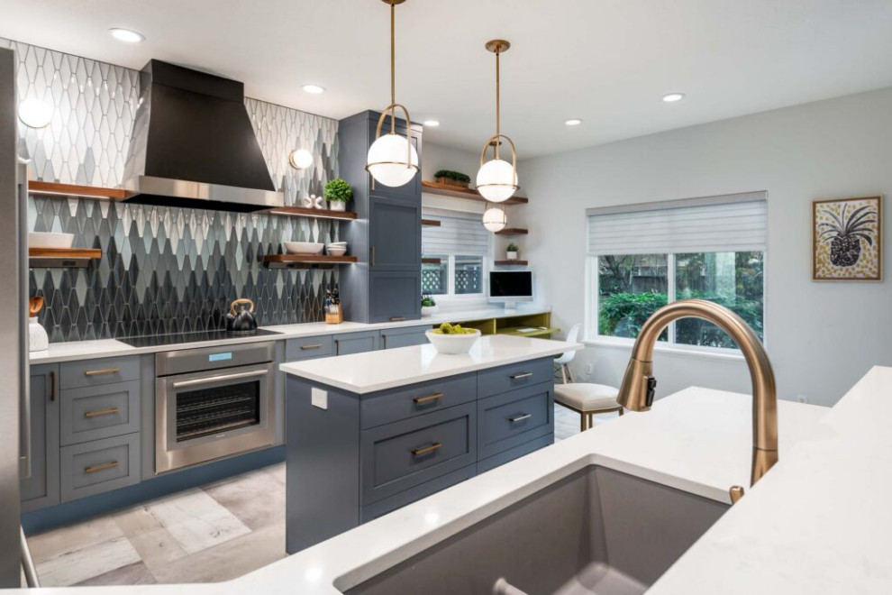 Inspiration for a transitional galley vinyl floor and gray floor kitchen remodel with an undermount sink, shaker cabinets, blue cabinets, quartz countertops, multicolored backsplash, ceramic backsplash, stainless steel appliances, a peninsula and white countertops