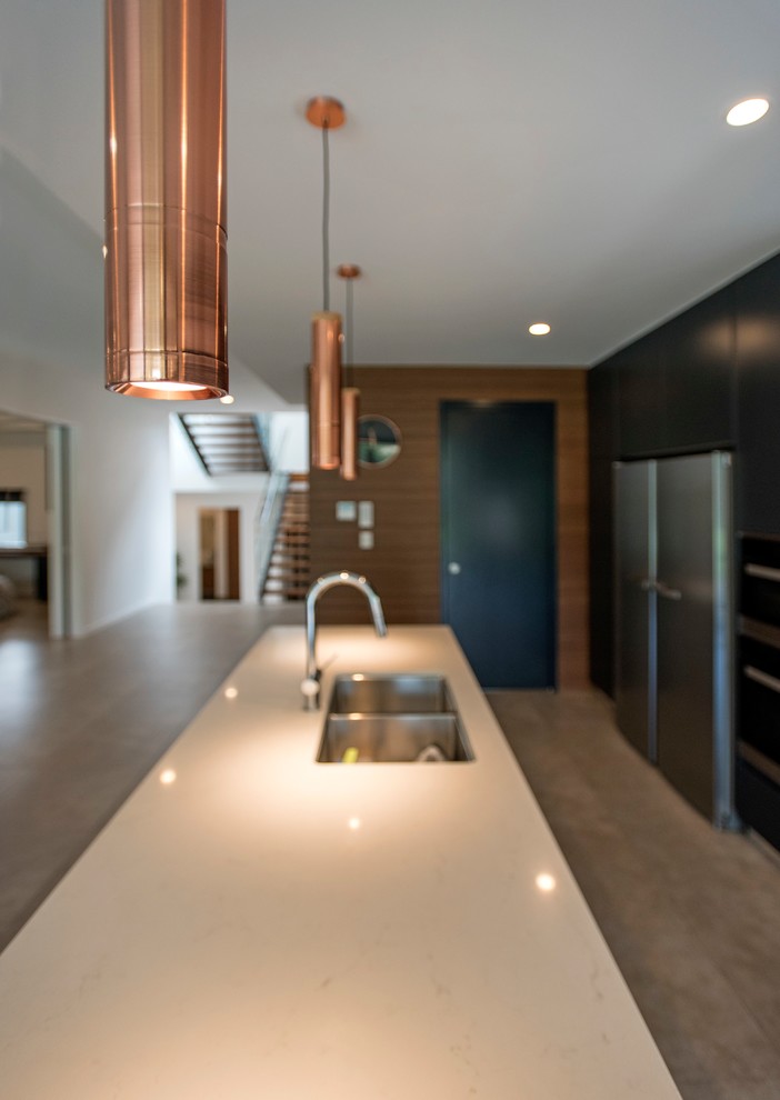 Inspiration for a contemporary galley open plan kitchen in Brisbane with black cabinets, window splashback, ceramic floors, with island, grey floor and white benchtop.