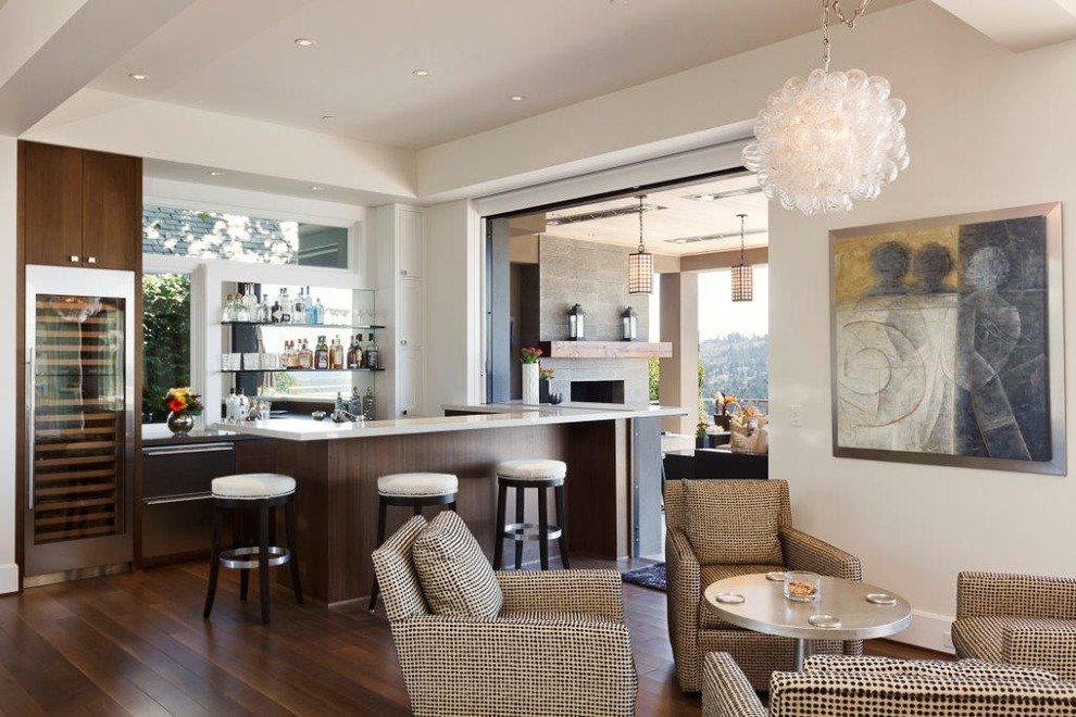 Contemporary living room in Portland with a home bar, beige walls and dark hardwood floors.