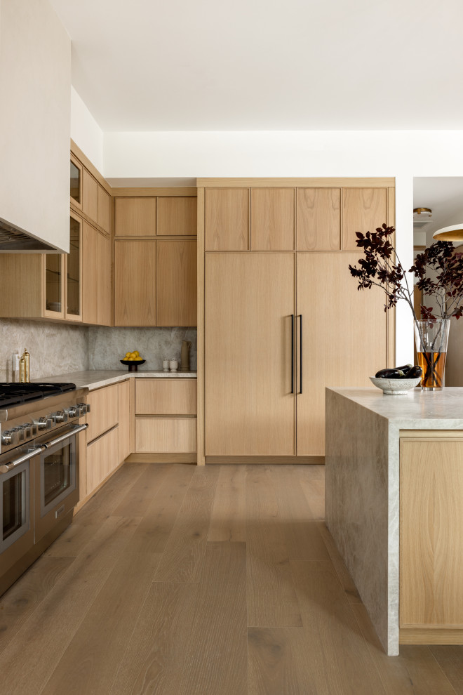 Kitchen - modern light wood floor and beige floor kitchen idea in Los Angeles with flat-panel cabinets, beige cabinets, quartzite countertops, beige backsplash, stainless steel appliances and beige countertops