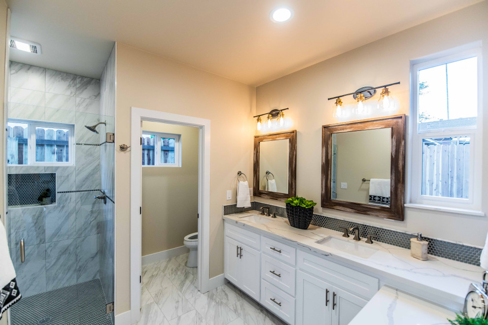 Photo of a mid-sized transitional 3/4 bathroom in Sacramento with shaker cabinets, white cabinets, beige tile, ceramic tile, an undermount sink, quartzite benchtops, white benchtops, a single vanity, a built-in vanity, a curbless shower and a hinged shower door.