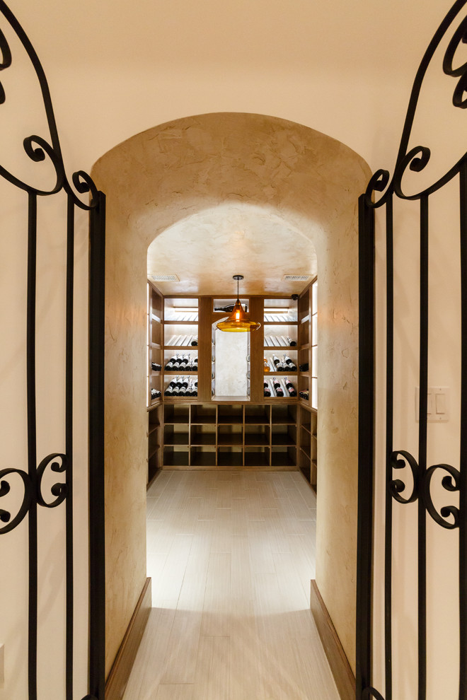 This is an example of an expansive modern wine cellar in New York with marble floors, storage racks and white floor.