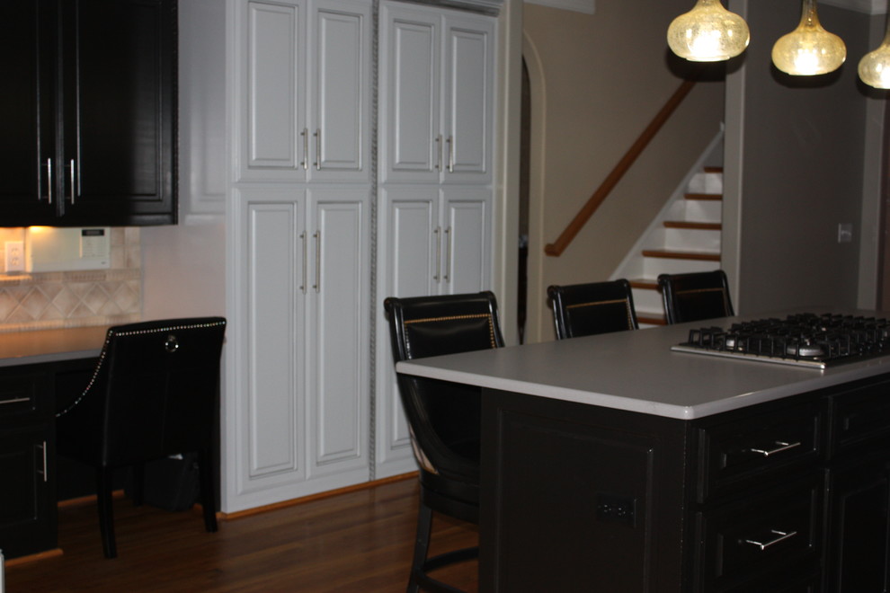 Eat-in kitchen - large transitional u-shaped light wood floor eat-in kitchen idea with a double-bowl sink, raised-panel cabinets, gray cabinets, quartz countertops, beige backsplash, ceramic backsplash, stainless steel appliances and an island