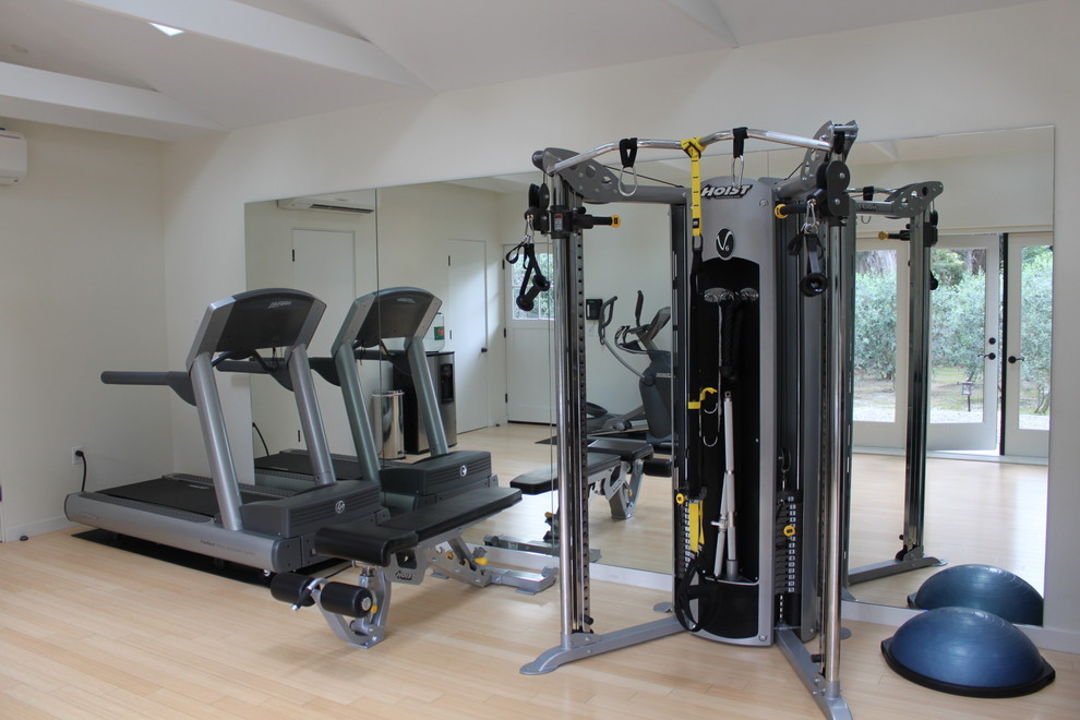 Photo of a mid-sized beach style multipurpose gym in Santa Barbara with white walls and bamboo floors.