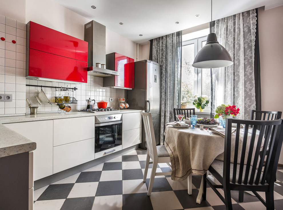 This is an example of a mid-sized scandinavian l-shaped separate kitchen in Other with flat-panel cabinets, white splashback, stainless steel appliances, no island and multi-coloured floor.