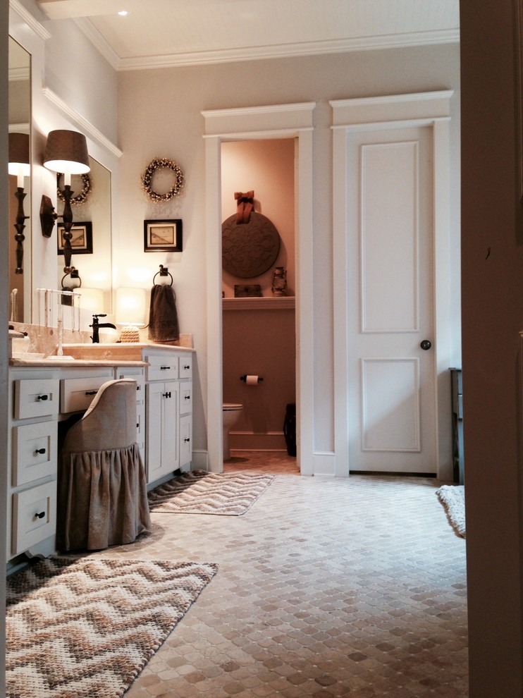This is an example of a traditional bathroom in Dallas with white cabinets.