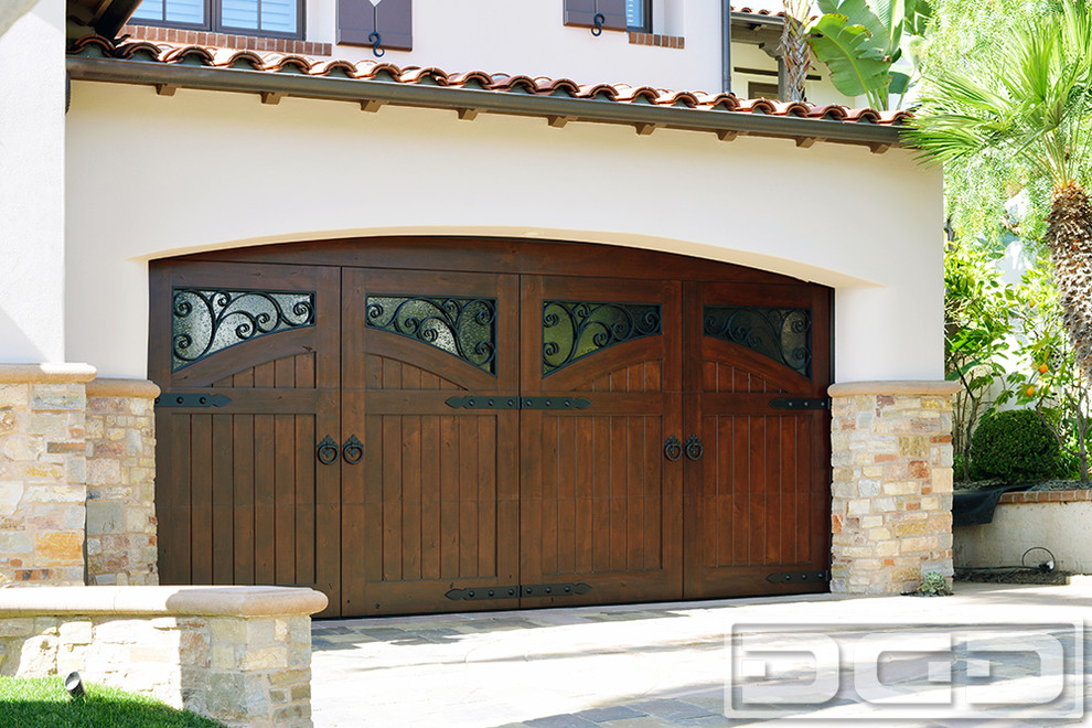 Design ideas for a mid-sized mediterranean attached two-car garage in Orange County.