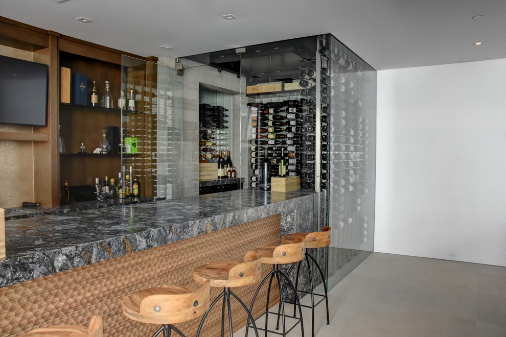 Inspiration for a mid-sized modern wine cellar in Orange County with ceramic floors, display racks and beige floor.