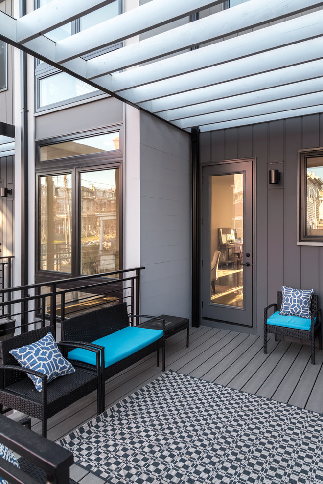Photo of a small contemporary balcony in DC Metro with an awning and metal railing.