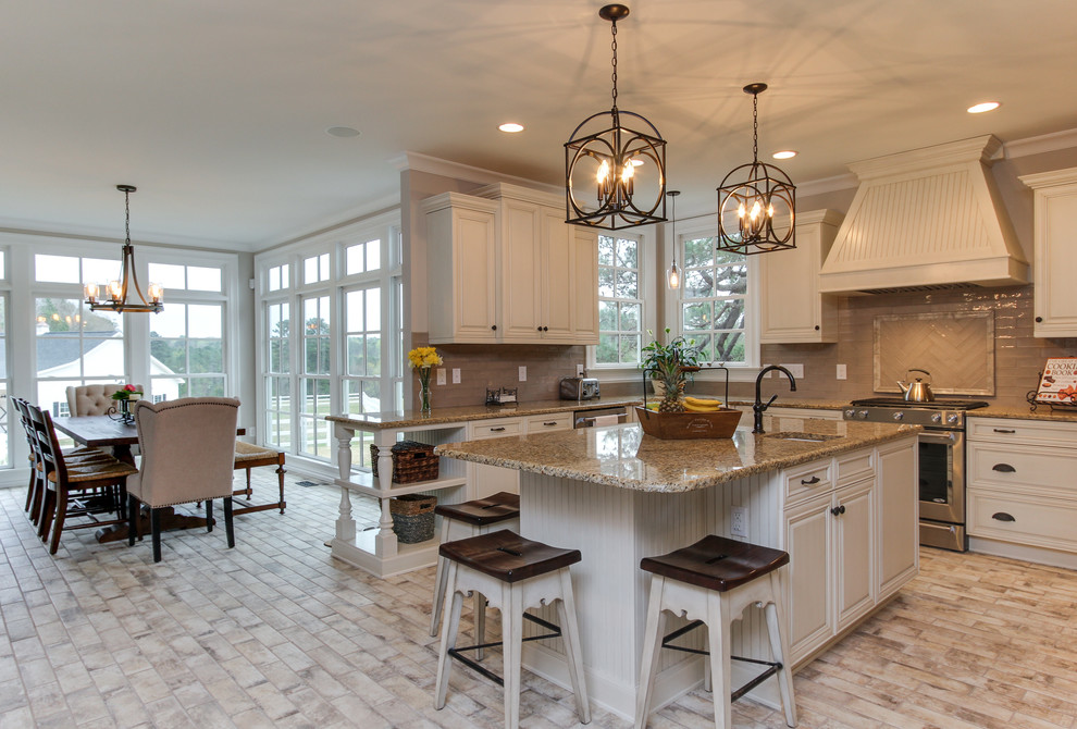 Photo of a large country u-shaped eat-in kitchen in Raleigh with a farmhouse sink, shaker cabinets, beige cabinets, granite benchtops, grey splashback, ceramic splashback, stainless steel appliances, brick floors, with island and white floor.