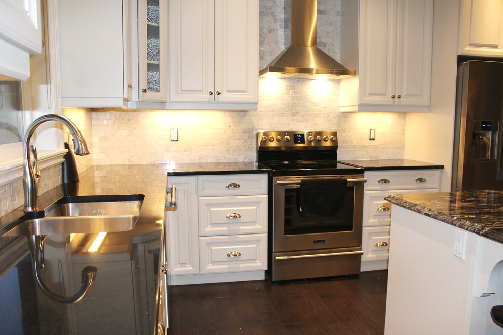 Example of a mid-sized l-shaped dark wood floor open concept kitchen design in Toronto with an undermount sink, raised-panel cabinets, white cabinets, quartzite countertops, gray backsplash, subway tile backsplash, stainless steel appliances and an island