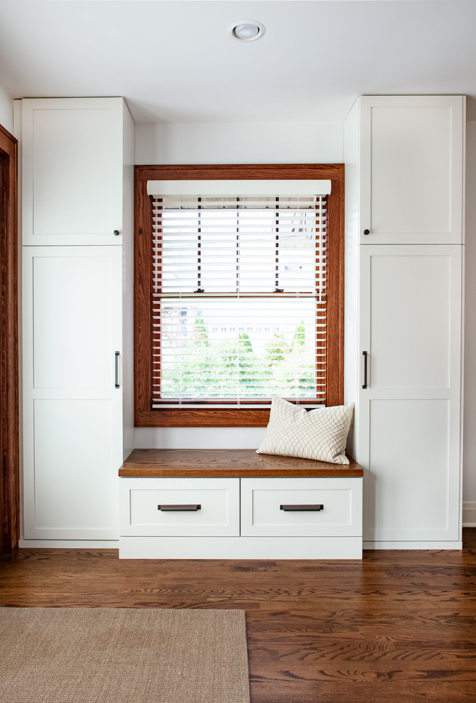 Transitional dark wood floor and brown floor foyer photo in Chicago with white walls