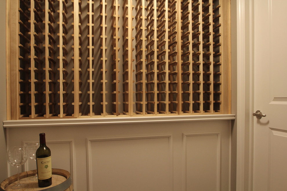 Photo of a small transitional wine cellar in Cedar Rapids with laminate floors and storage racks.