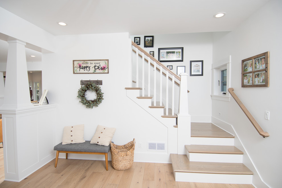 Mid-sized country wood l-shaped staircase in Portland with painted wood risers and wood railing.