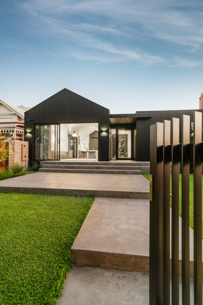 Inspiration for a medium sized and black modern bungalow detached house in Perth with wood cladding, a pitched roof, a metal roof, a black roof and board and batten cladding.