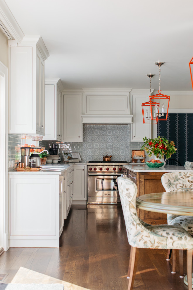 Transitional u-shaped dark wood floor and brown floor eat-in kitchen photo in Chicago with a double-bowl sink, shaker cabinets, white cabinets, quartzite countertops, blue backsplash, ceramic backsplash, stainless steel appliances, an island and white countertops