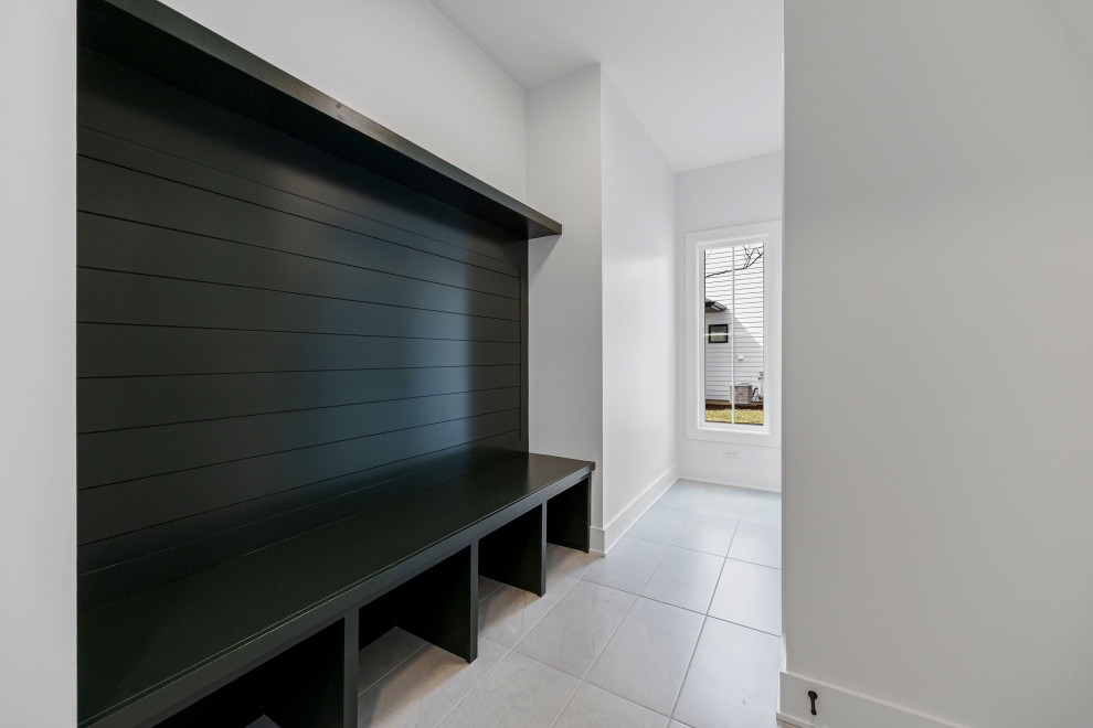 Inspiration for a small transitional ceramic tile, gray floor and shiplap wall mudroom remodel in Chicago with white walls