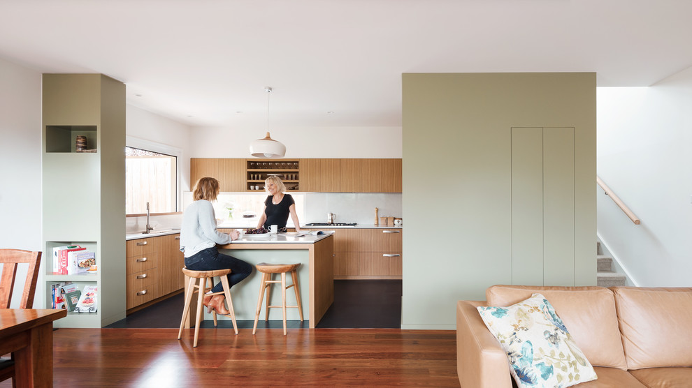 Inspiration for a mid-sized contemporary u-shaped kitchen in Melbourne with a double-bowl sink, quartz benchtops, white splashback, stone slab splashback, stainless steel appliances and with island.