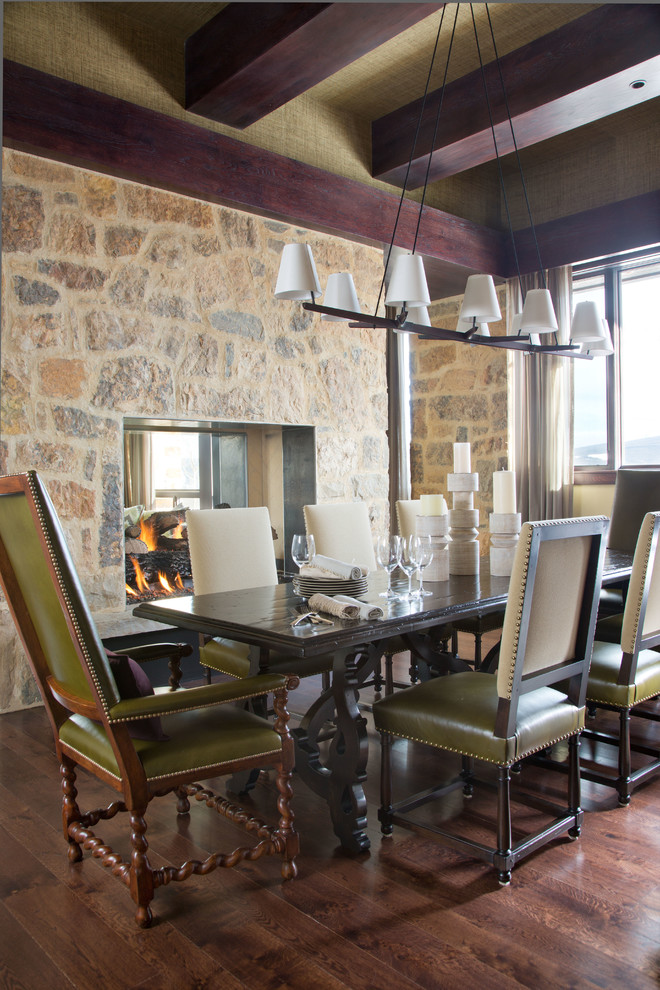 This is an example of a country dining room in Denver with dark hardwood floors.