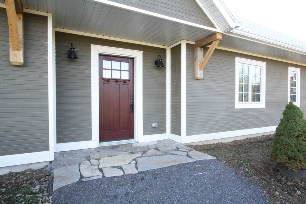 Inspiration for a mid-sized transitional gray one-story wood gable roof remodel in Toronto