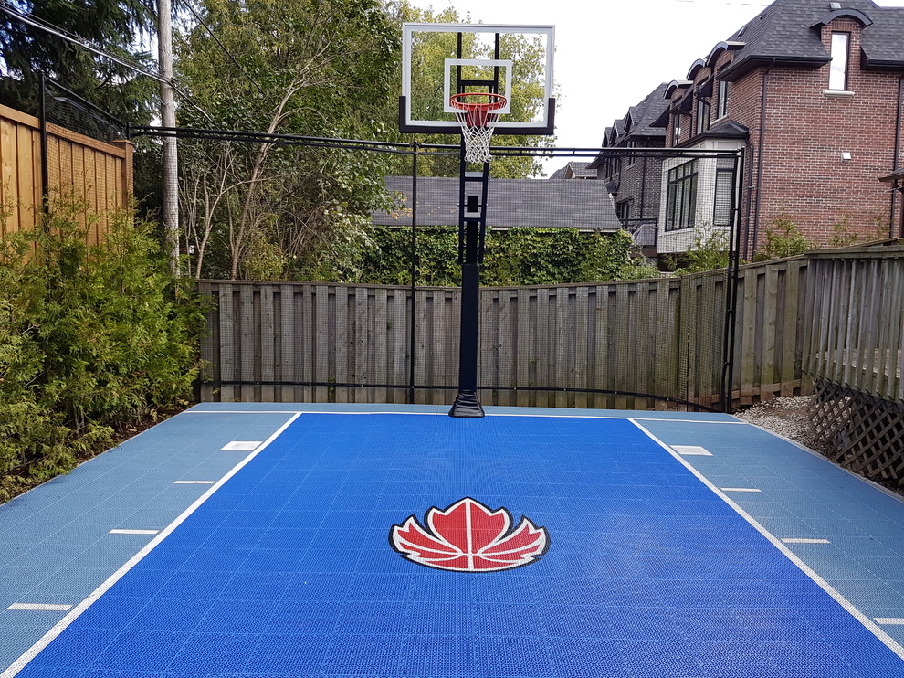 Photo of a mid-sized traditional backyard partial sun outdoor sport court for summer in Toronto with with outdoor playset and concrete pavers.