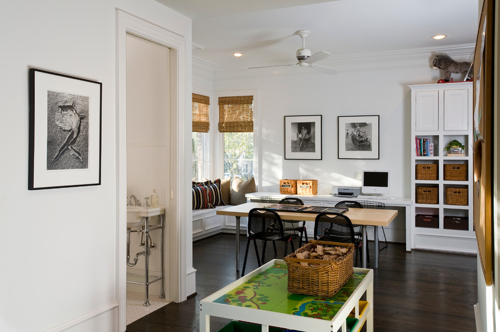 Traditional gender-neutral kids' playroom in Houston with white walls and dark hardwood floors.