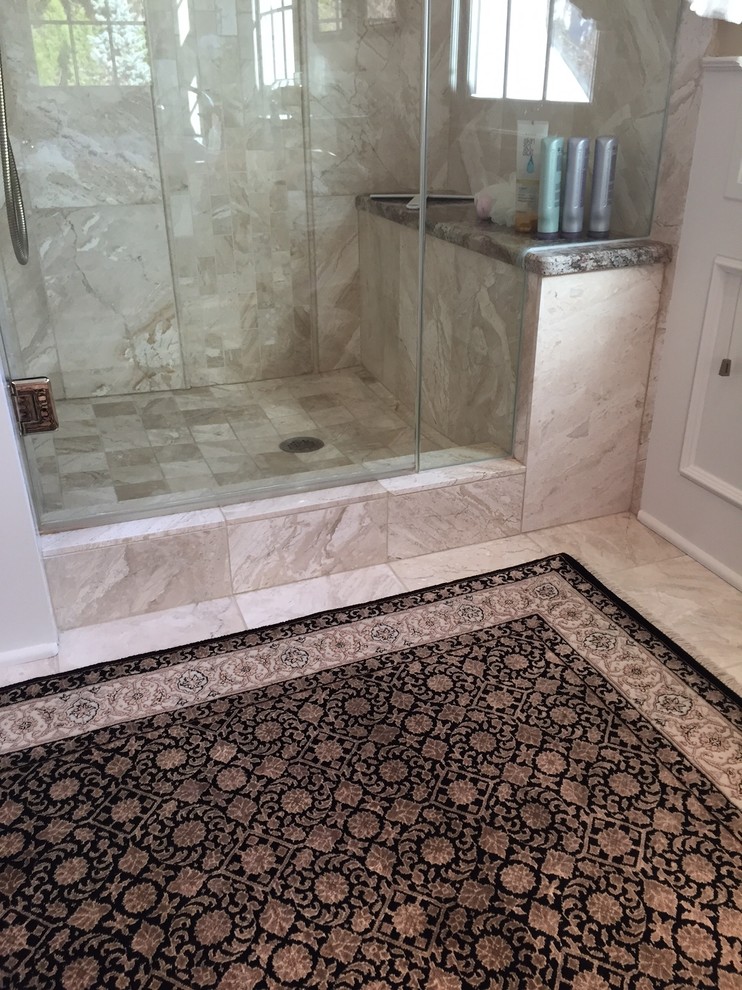 This is an example of a mid-sized traditional bathroom in Milwaukee with recessed-panel cabinets, white cabinets, a corner shower, beige tile, ceramic tile, beige walls and ceramic floors.