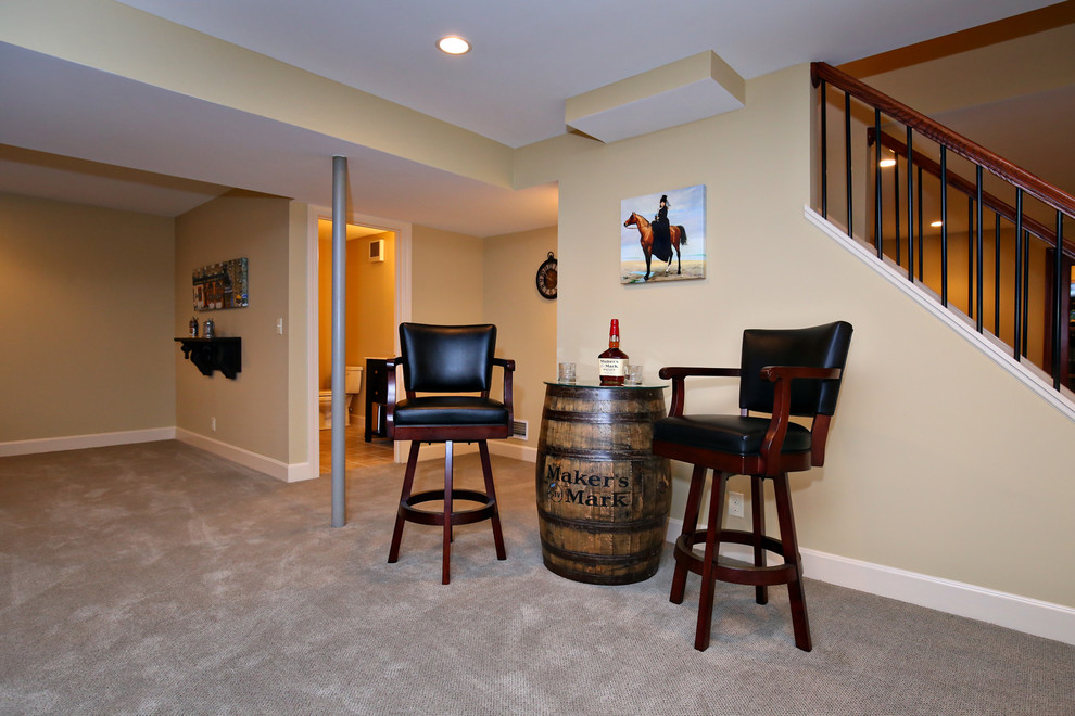 Elegant carpeted basement photo in Louisville with yellow walls and no fireplace