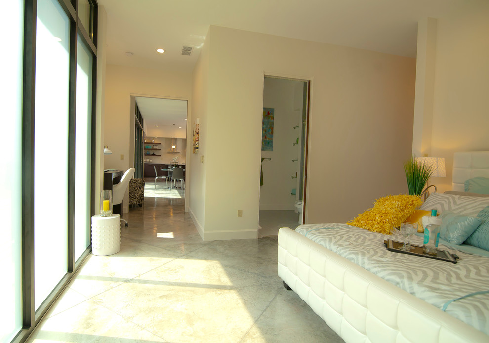 Inspiration for a mid-sized contemporary master bedroom in Orlando with white walls, concrete floors and no fireplace.
