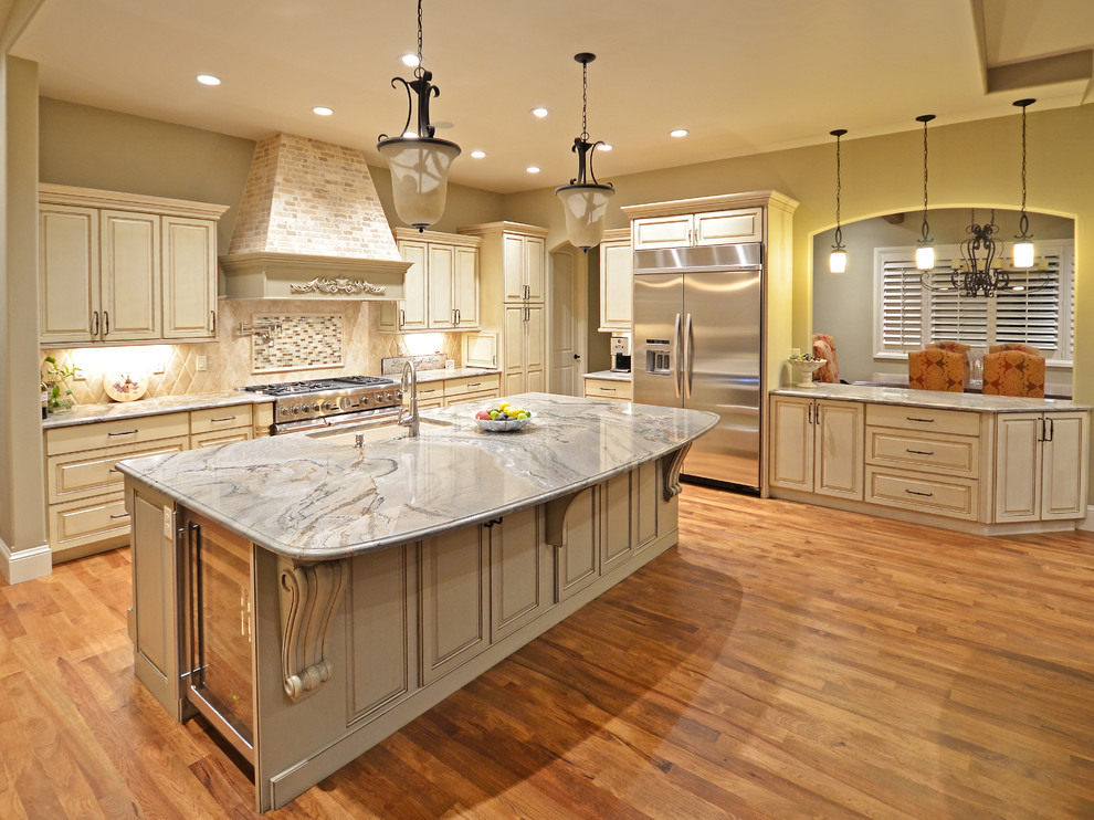 Elegant l-shaped kitchen photo in Denver with an island